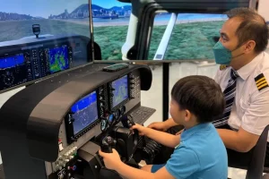 a person is playing with an airplane simulator